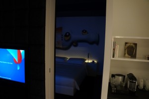 a door with a picture of a bed and a tv