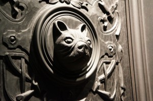 a carved wooden door with a dog head