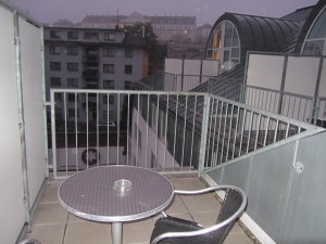 a table and chair on a balcony