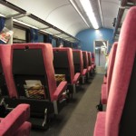 a row of red seats in a train