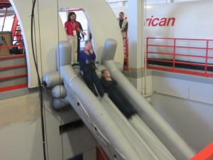 people on a slide at an airport