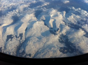 a view of snow covered mountains from an airplane window
