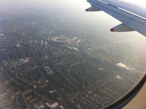 an airplane wing and city view from the window