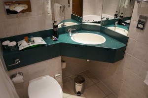 a bathroom with a green countertop and a toilet