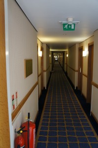a long hallway with a fire extinguisher