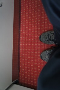 a person's feet on a red carpet