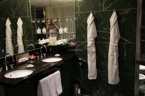 a bathroom with white towels on the wall