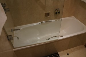 a bathtub with a glass door