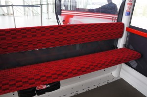 a red and black seat on a bus