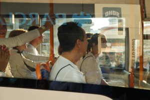 people on a bus looking out a window