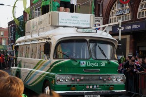 a green and white bus on a street