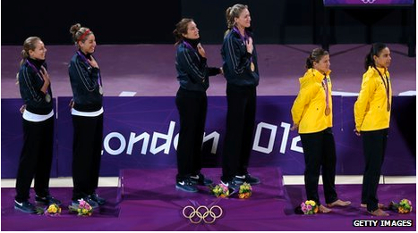 a group of women standing on a podium