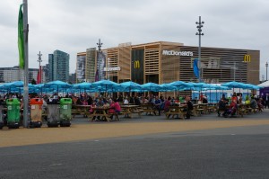 a group of people sitting at tables with umbrellas