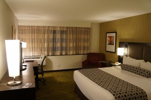 a hotel room with a bed and desk
