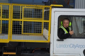 a man in a yellow vest in a truck
