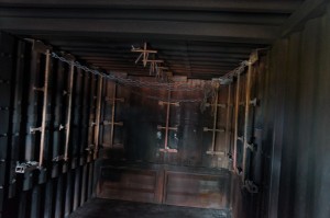 a dark room with wooden bars