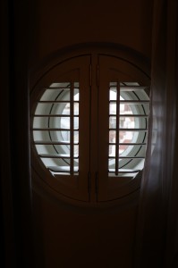 a round window with shutters