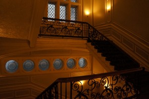 a staircase with a railing and windows