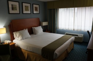a hotel room with a bed and a window