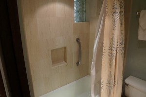 a shower with a metal bar
