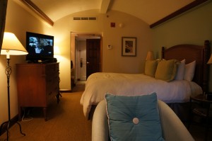 a bedroom with a bed and a television