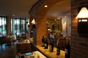 a restaurant with wine bottles on the counter