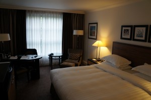 a hotel room with a bed and a chair