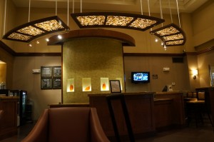 a reception area with lights from the ceiling