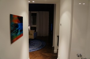 a hallway with a painting on the wall
