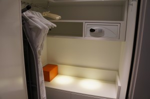 a white closet with a shelf and a white box
