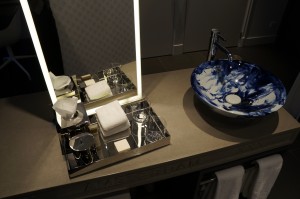 a bathroom sink with a mirror and a tray of soap