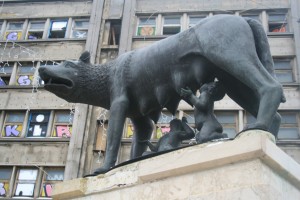 a statue of a wolf with a group of children