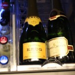 two bottles of champagne on a shelf