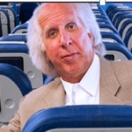 a man in a suit sitting in a plane