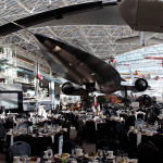 a large room with tables and chairs and a plane