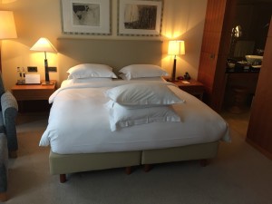 a bed with pillows and lamps in a room