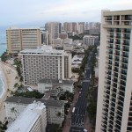 a city with many tall buildings and a beach