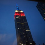 a tall building with a red and blue light
