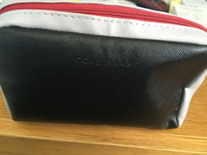 a close up of a black and red zippered bag