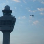 a helicopter flying over a control tower