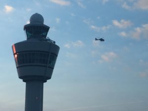 a helicopter flying over a control tower
