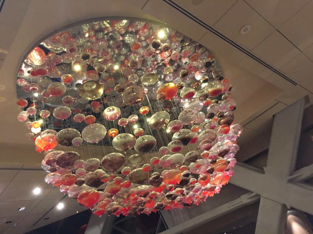 a large chandelier with colorful balls from the ceiling