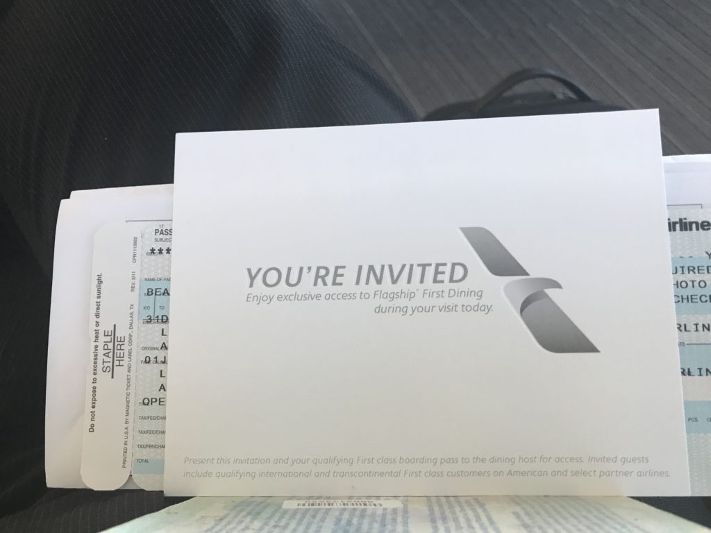 a white envelope with a logo and a couple tickets