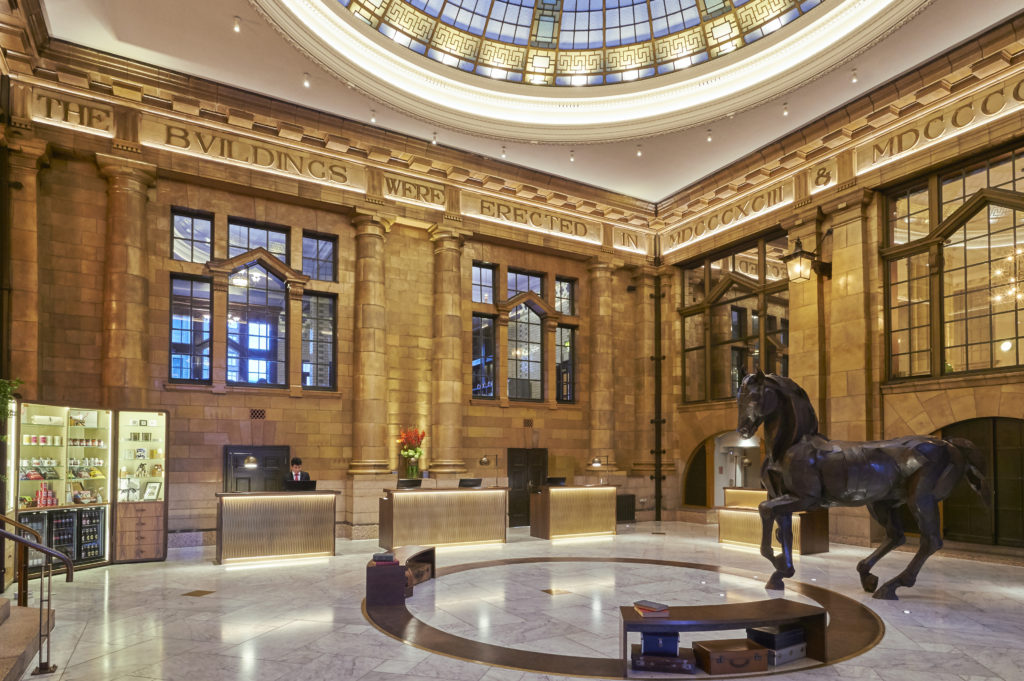 a lobby of a building with a statue of a horse