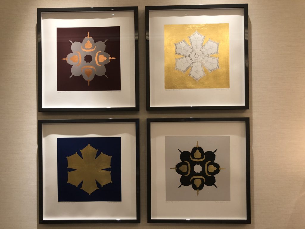 a group of framed art on a wall
