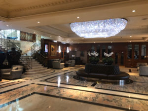 a large lobby with a chandelier and a couch
